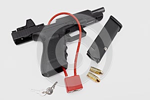 Locked disarmed and secured automatic gun on white background
