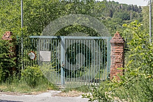 Locked gate of an abandoned object in the forest