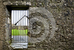 Locked gate in old stone wall