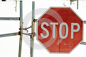 Locked gate with a stop sign