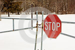 Locked gate with a stop sign