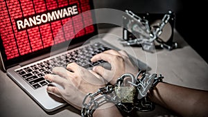 Locked hands and ransomware cyber attack on laptop