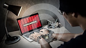 Locked hands and ransomware cyber attack on laptop