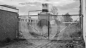 Locked iron gate near a closed factory Almelo, Netherlands