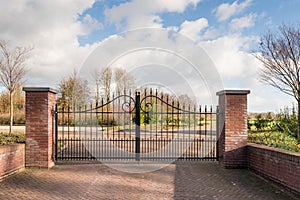 Locked iron gate of a new cemetery