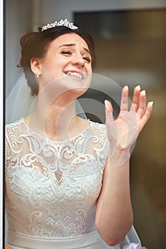 Locked joyful young bride asked to open the door