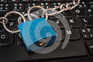 Locked laptop with chain and padlock