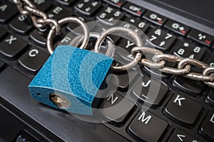 Locked laptop with chain and padlock