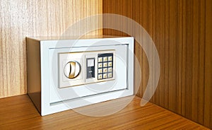 Locked metal security safes inside wooden cupboard