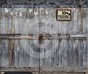 Locked old wooden door with sign