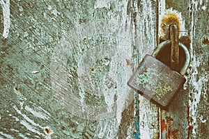 Locked padlock on grunge metal background