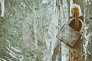 Locked padlock on grunge metal background photo