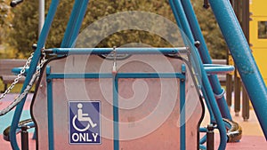 Locked swing for wheelchair users on an empty playground