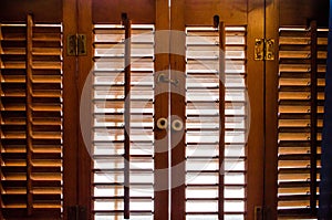 Locked wooden window shutters from the inside photo