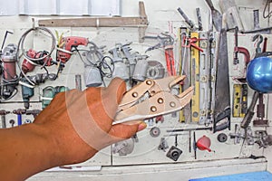 Locking pliers in hand tool background.