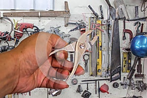 Locking pliers in hand tool background.