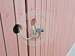 Locking security cable tied between two wooden doors