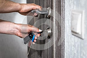 Locking up or unlocking entrance door with key in hand