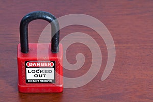 Lockout Padlock red color on wood background photo