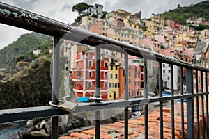 Locks attached to metal frame in touristic village of Riomaggiore