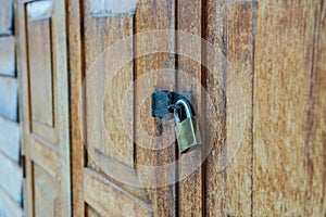 Lockset on wooden door pattern textured background, antique place in Thailand.