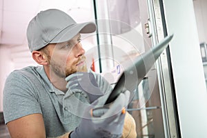 locksmith holding tablet and screwdriver