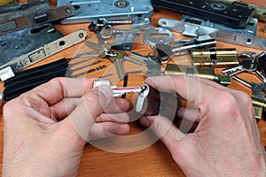 Locksmith inserts key in cylinder lock