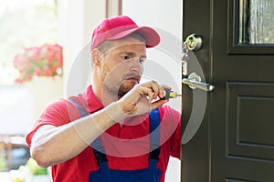Locksmith in installing new house door lock photo