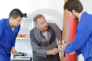 locksmith students training in workshop with teacher