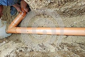 A locksmith supplies a sewer pipe to the sump