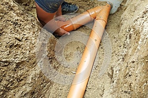 A locksmith supplies a sewer pipe to the sump