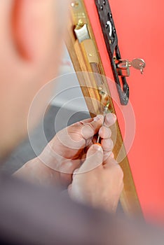 locksmith working with door lock