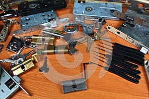 Locksmith workshop. Keys, locks and picklocks on table
