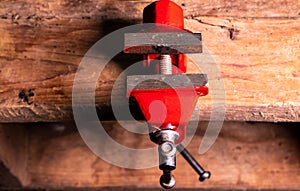 Locksmiths tool metal vise fixed on a wooden table