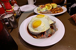 Loco Moco , traditional Hawaiian cuisine , burger patty on rice with a fried egg and brown gravy sauce