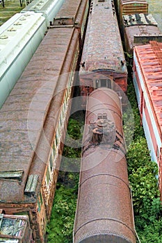 Locomotive engine and passenger cars out in elements