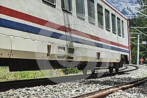 A locomotive on a rail road in a small town, close up