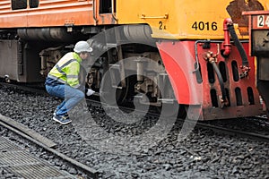 Locomotive repair worker, Train Engineer technician on duty working Maintenance Rolling Stocks of old diesel train passenger cabin