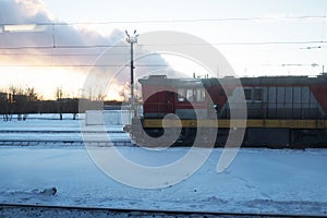 Locomotive train, in winter, at sunset.