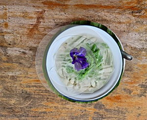 Lod chong ice thai sweet dessert traditional street food. coconut palm sugar syrup ingredient decoration with butterfly pea flower