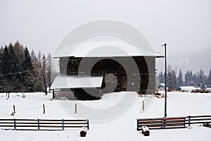 Lodges, snow roof background, winter in Dolomiti mountains, in Cadore, Italy