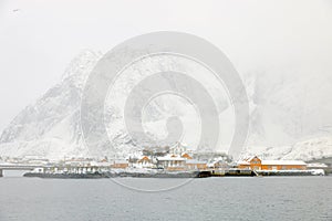 Reine fishing village on Lofoten islands with yellow rorbu houses in winter with snow. Lofoten islands, Norway, Europe