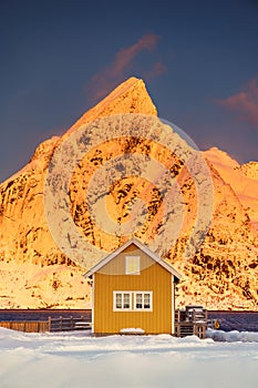 Lofoten islands beautiful nature landscape in Norway and fishing town with scenic yellow rorbu house of Sakrisoy, Reine