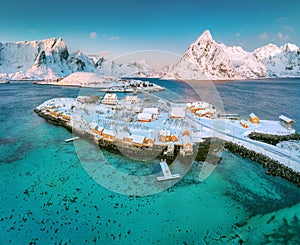 Lofoten islands beautiful naturesunrise landscape in Norway and fishing town with scenic yellow rorbu houses of Sakrisoy, Reine