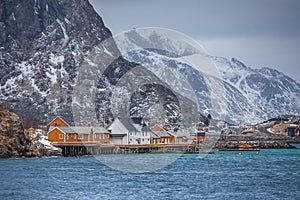 Lofoten Islands, dramatic landscape at sunset. dark clouds over the fishing village, boats and mountain peaks