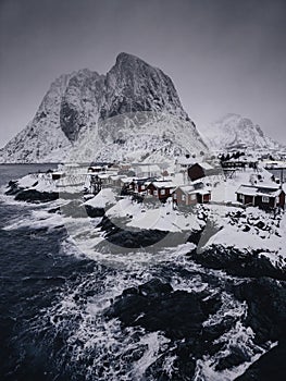 Lofoten Islands, Reine, Norway and Hamnoy fishing village with red rorbuer houses in winter nature panorama landscape