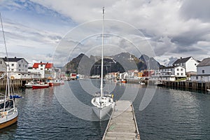 Lofoten, Norway - June 20, 2017: Scenic view of the waterfront harbor in Henningsvaer in summer. Henningsvaer is a fishing village