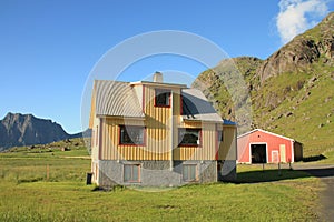Lofoten's ochre house and mountains photo