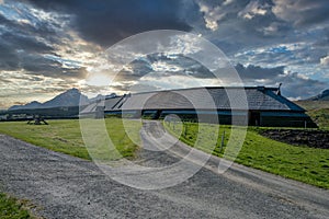 Lofotr long house, a home for vikings in the viking era, during sunset and dramatic skies.