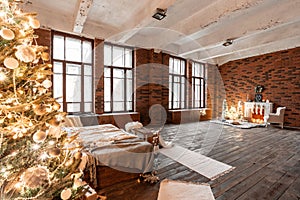 Loft apartments, brick wall with candles and Christmas tree wreath. White wool socks for Santa on the fireplace. Knitted
